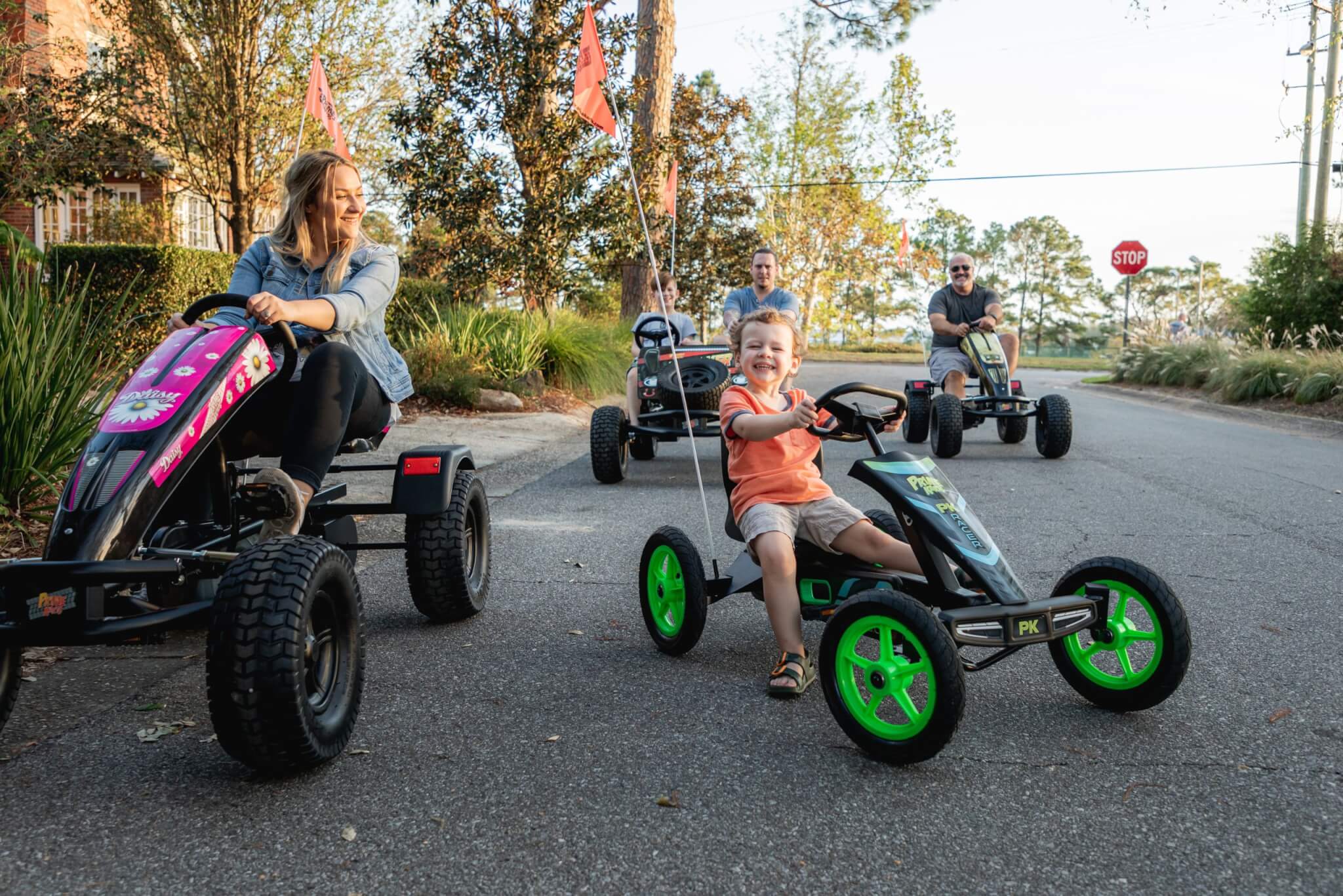 A family riding around on pedal karts.