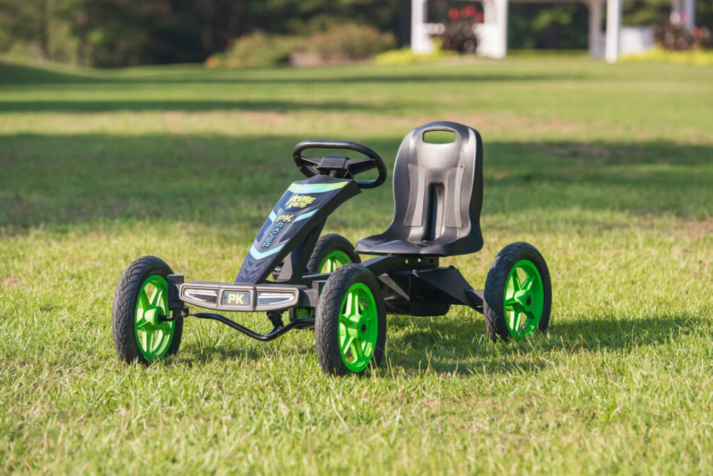 Green Prime Kart sitting on grass.