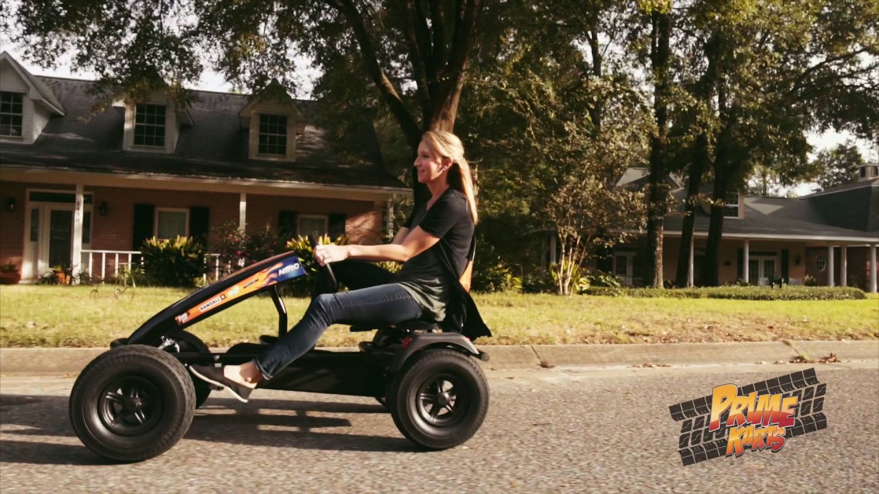 Woman riding pedal cart