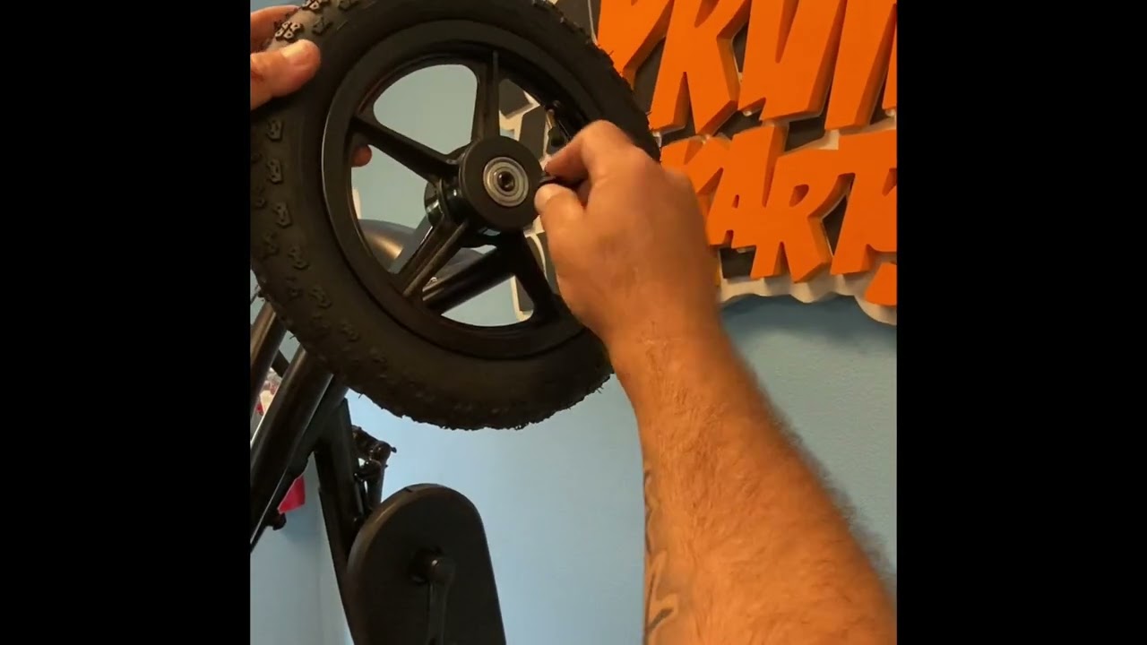 Man screwing on kart wheel